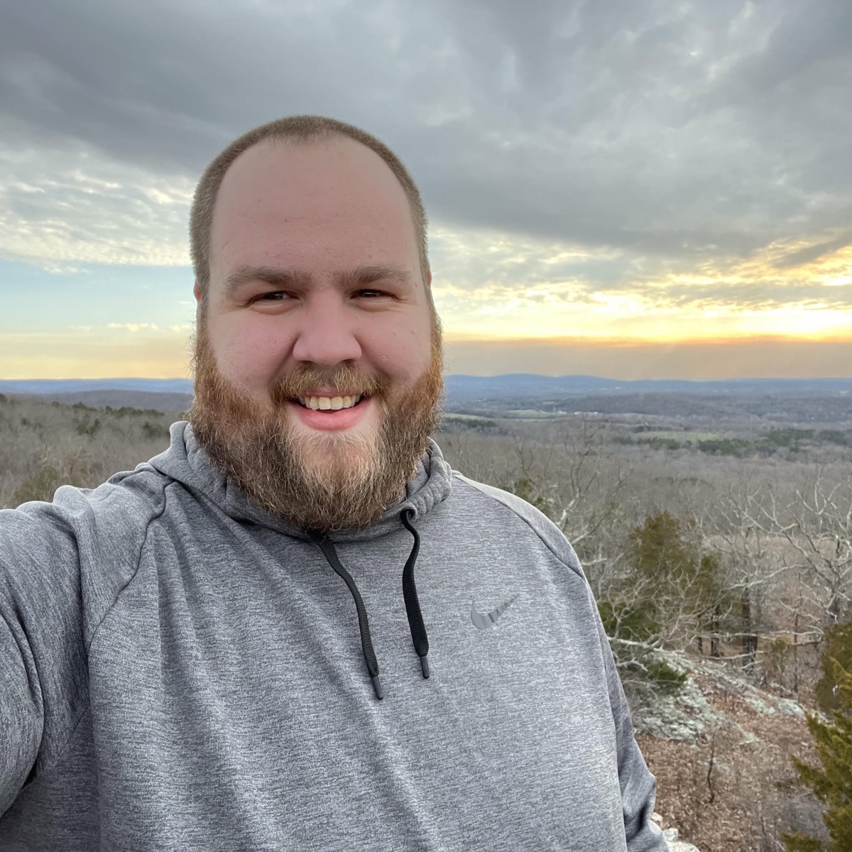CAPPSLOCK builder smiling outdoors at sunset